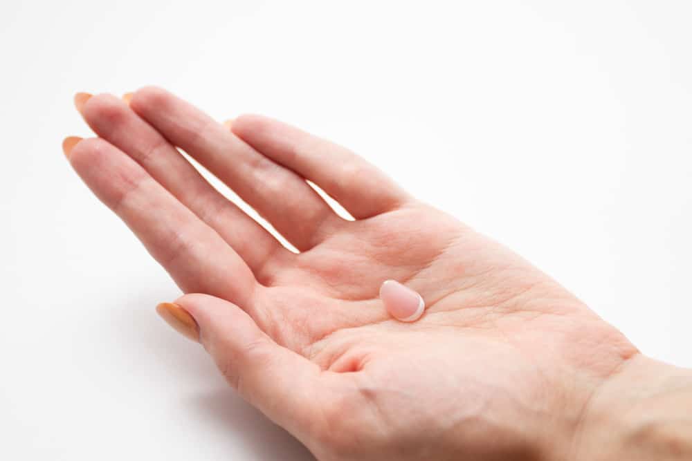 A broken false nail in the girl's hand