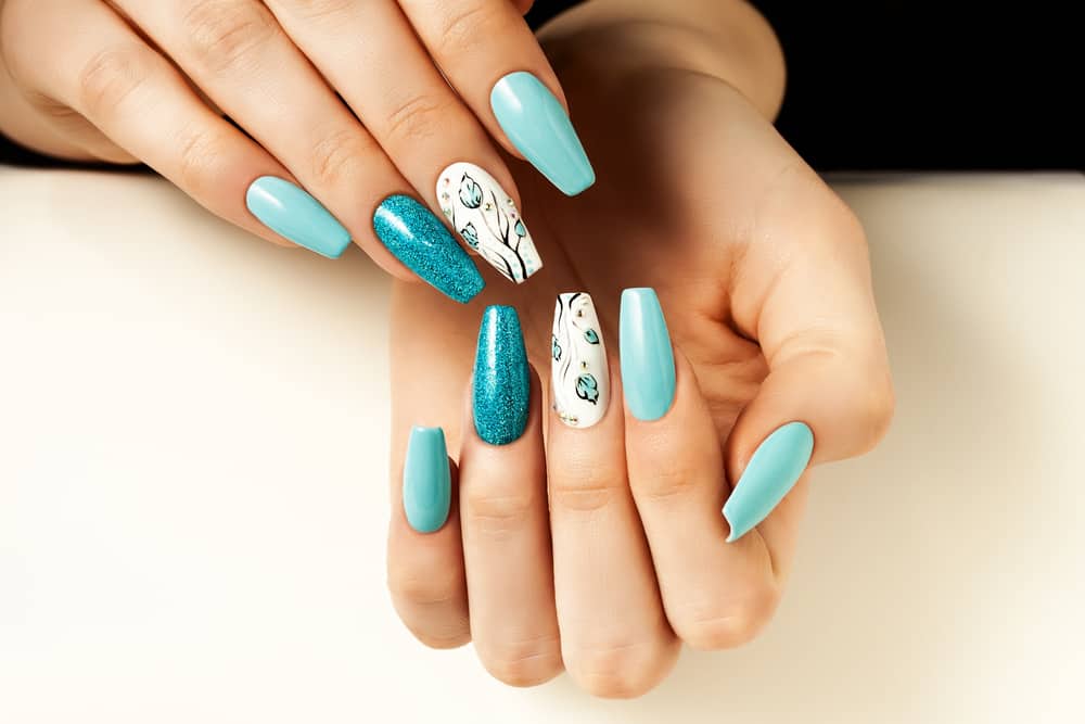 Blue female nails elongated with a design