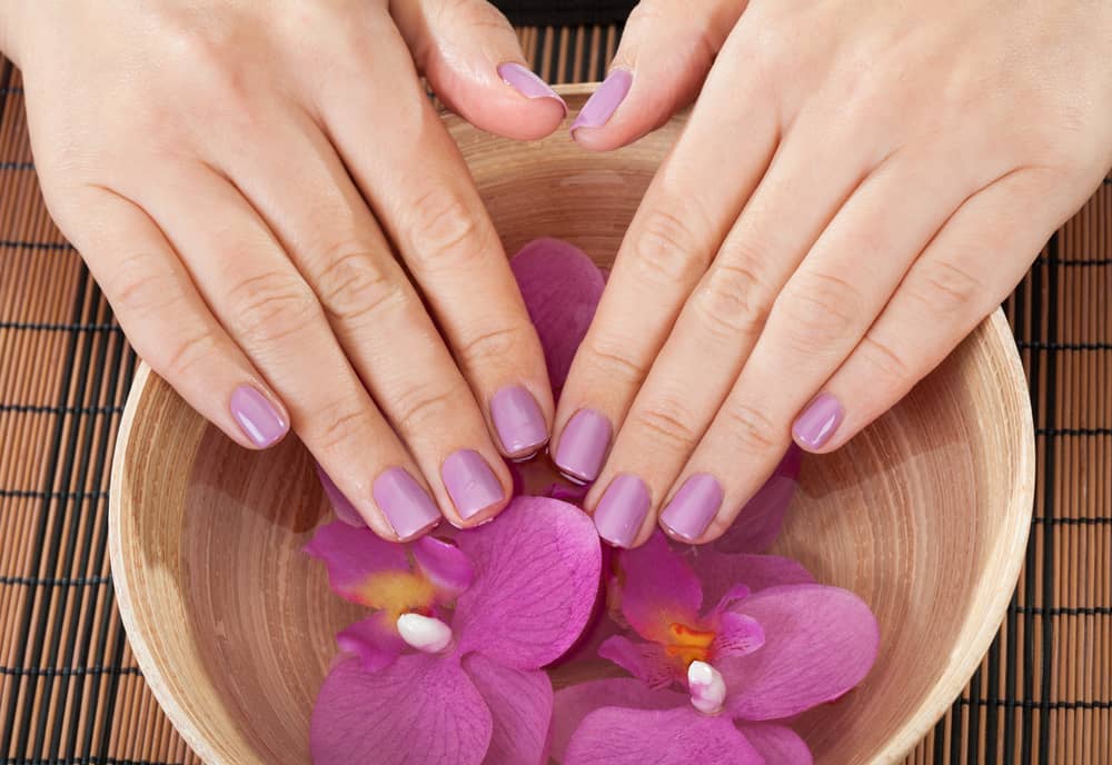 Close-up Of Female Hands Getting Manicure Treatment