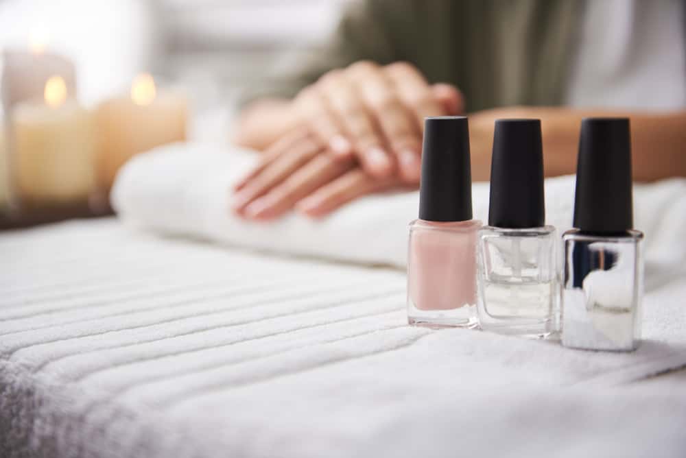 Close up of pink, clear and shiny nail varnishes