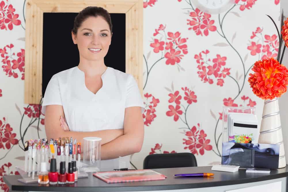 Confident woman at reception in nail salon