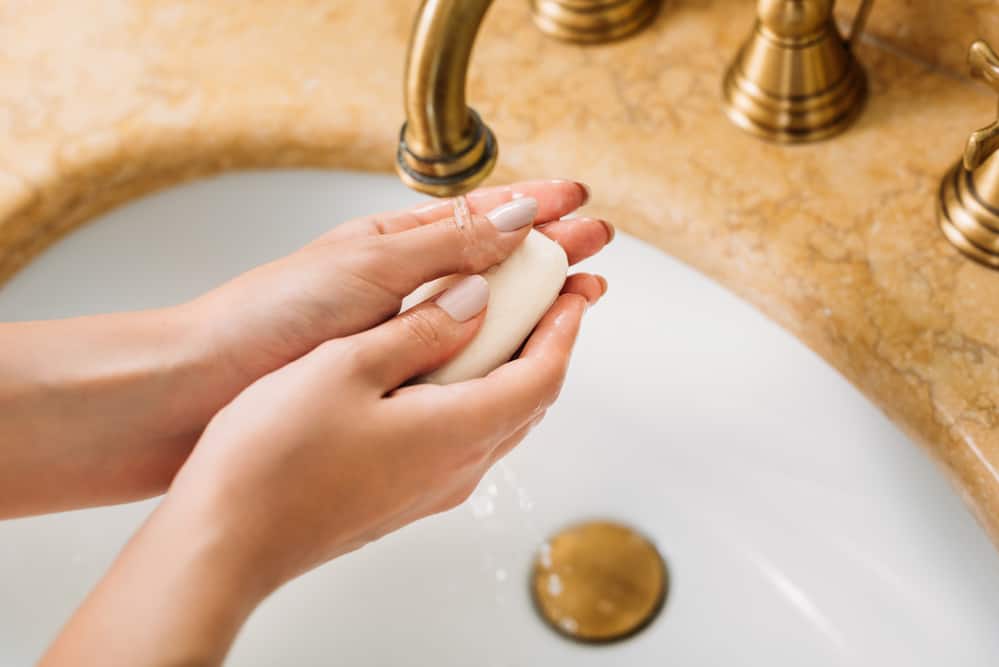 Cropped shot of woman washing hands with soap