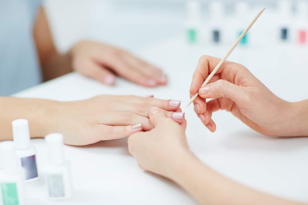 Female hands receiving a manicure