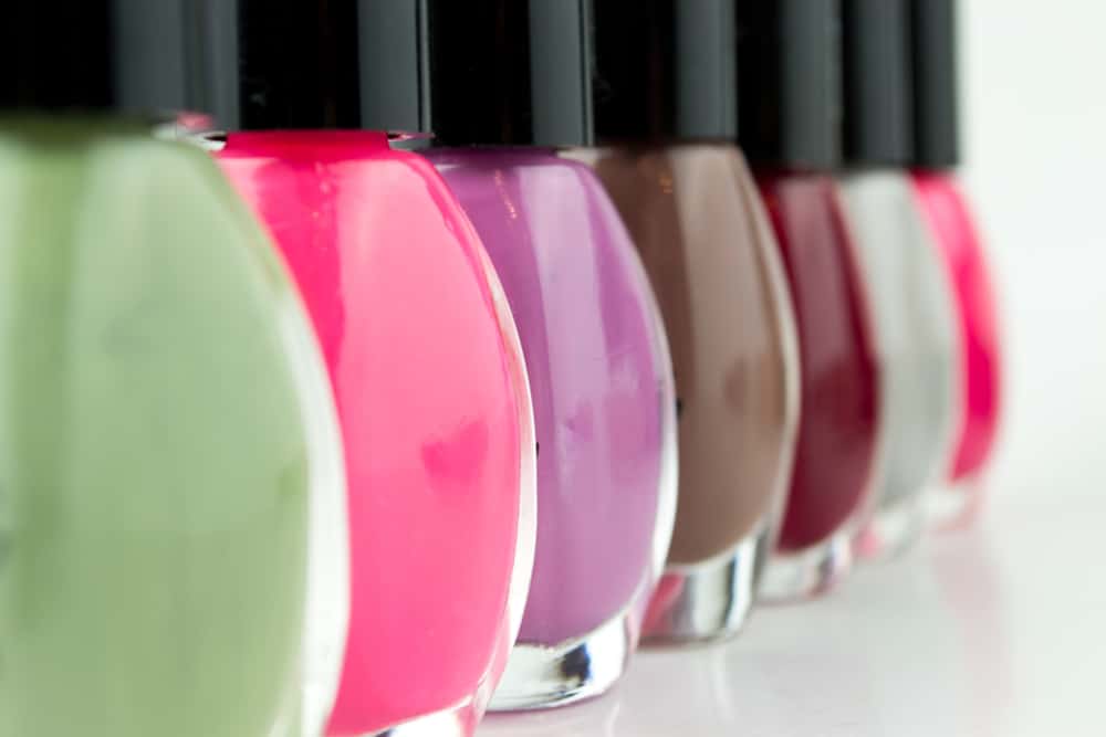 Group of bright nail polishes on white