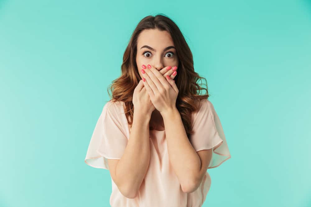 Portrait of a shocked young girl in dress