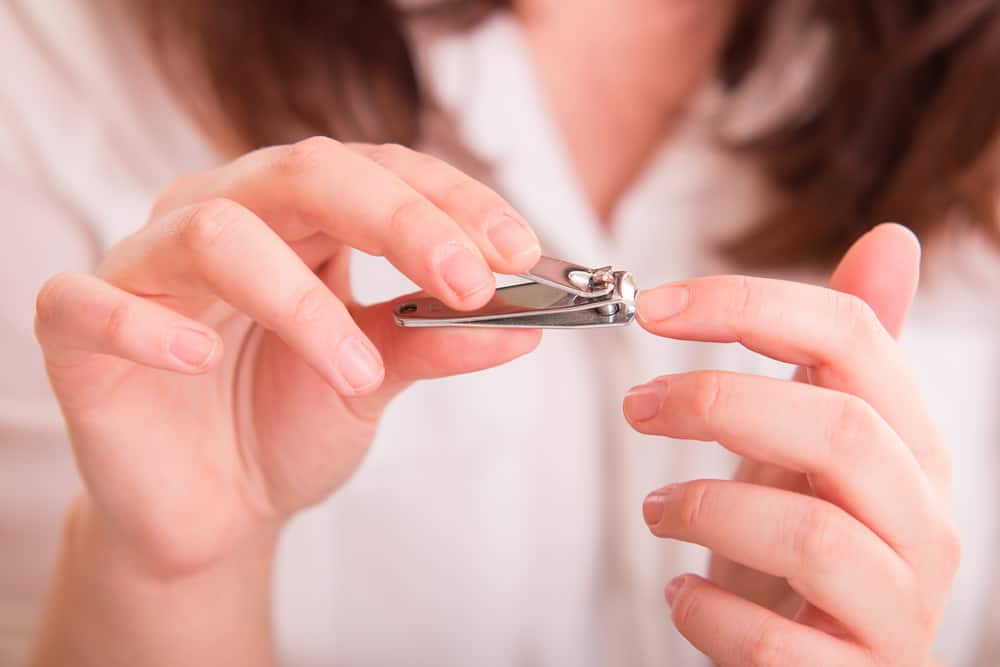 Woman cutting nails