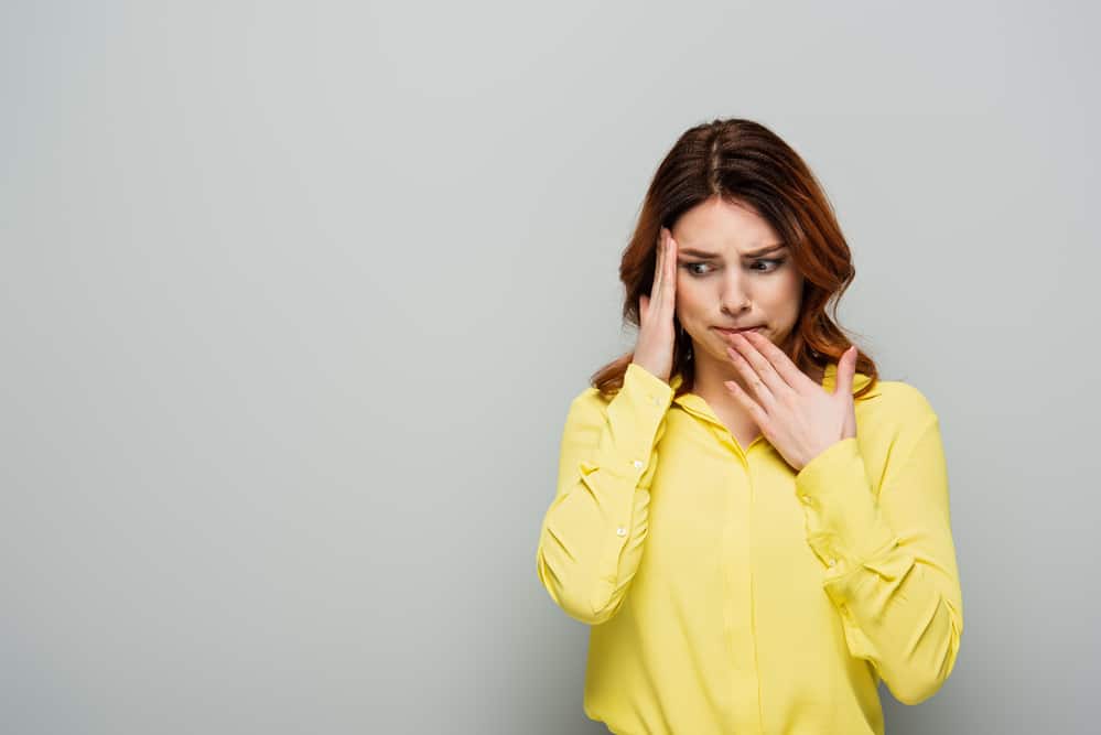 Worried woman in yellow shirt