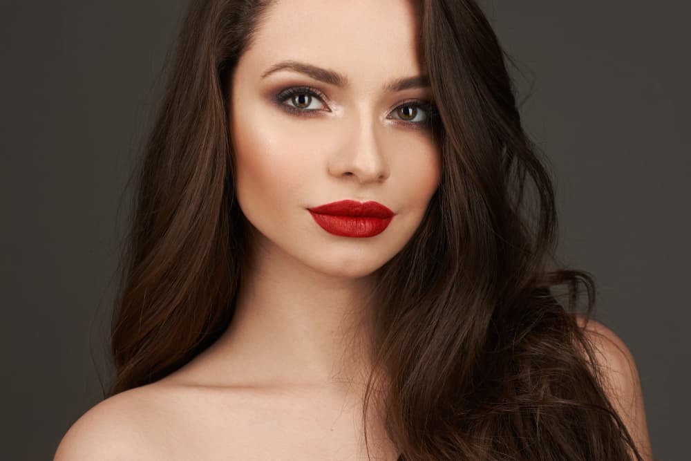 model with curly hairstyle and red lips