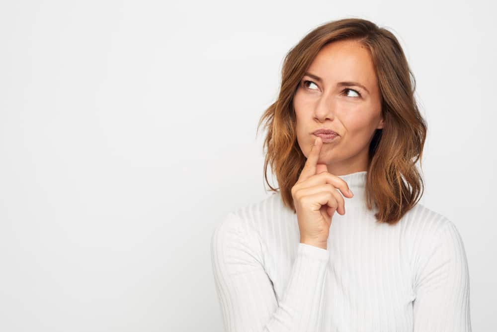 portrait of young woman thinking looks left