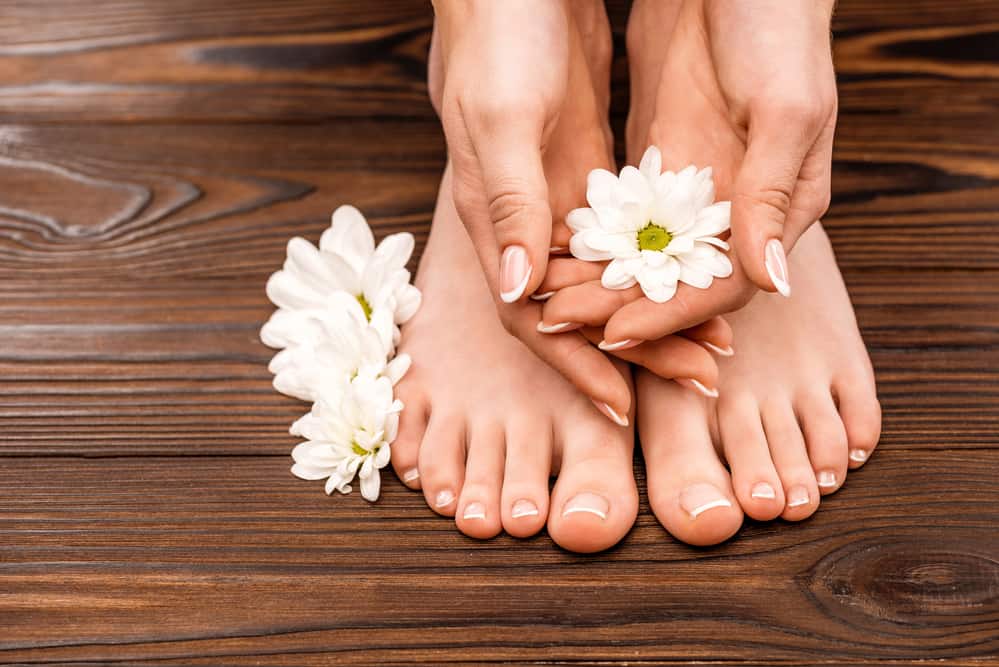 Cropped view of female hands and feet with medicine