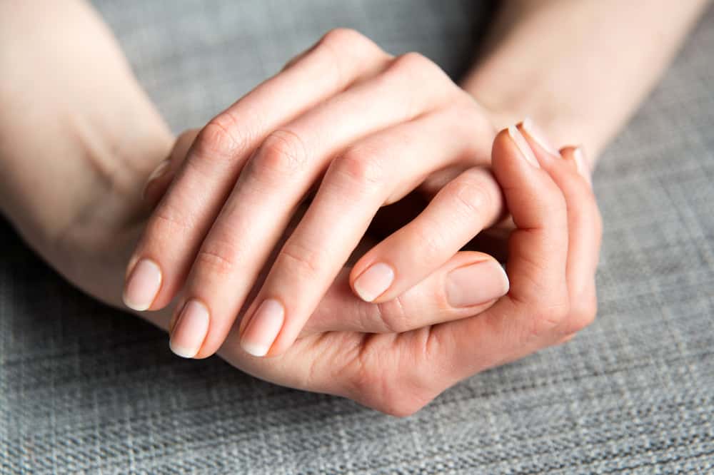 Female Hands on Gray Background