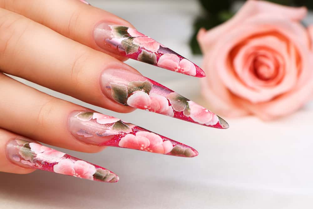 Female hand with beautiful floral design on nails.