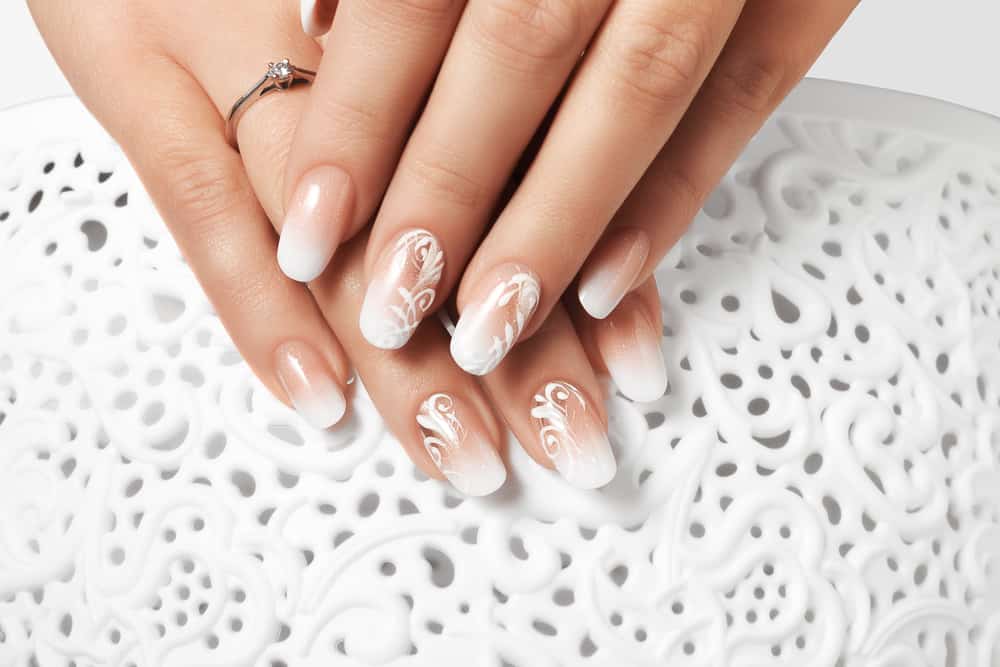 Manicure and white abstract pattern on women's nails