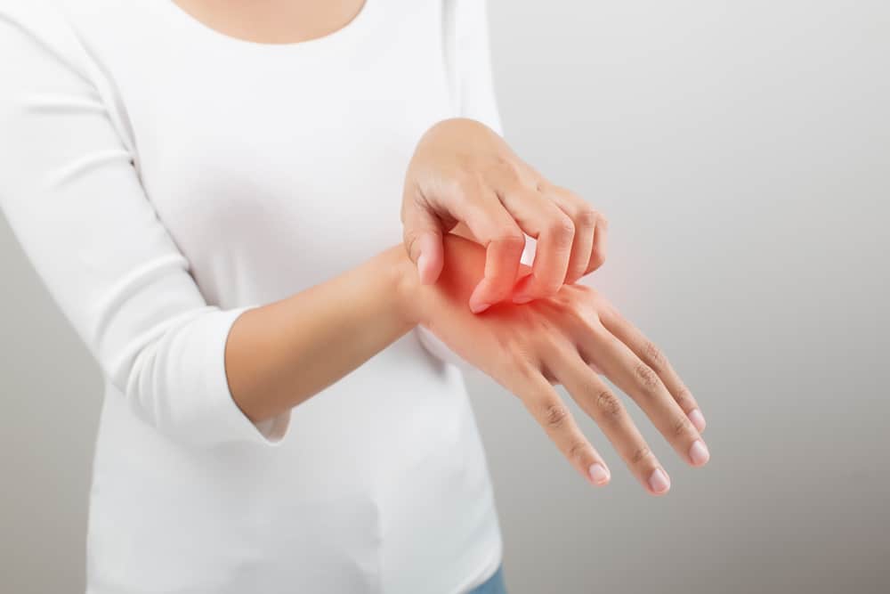 Women scratch the itch with hand, on white background