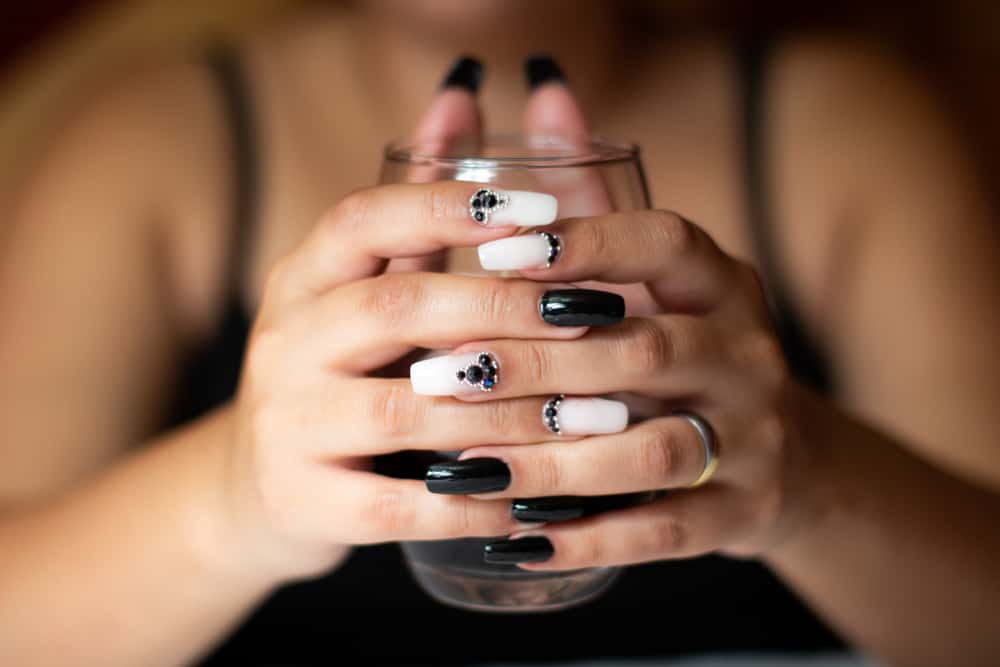 Black and white enameled polygel manicure. Glossy encrusted.