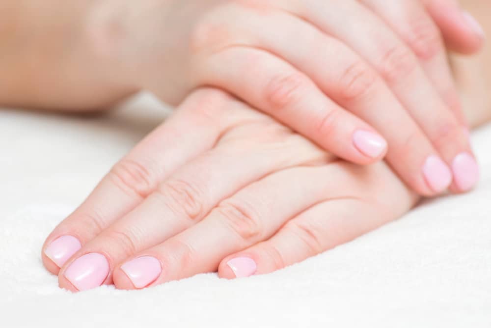 Closeup view of beautiful female hands on towel