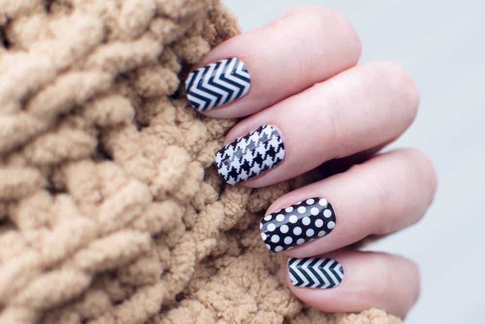 Hand with black and white patterned nails