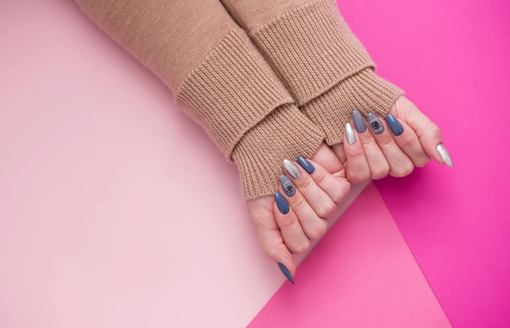 well-groomed women's hands with an interesting manicure on a pink background